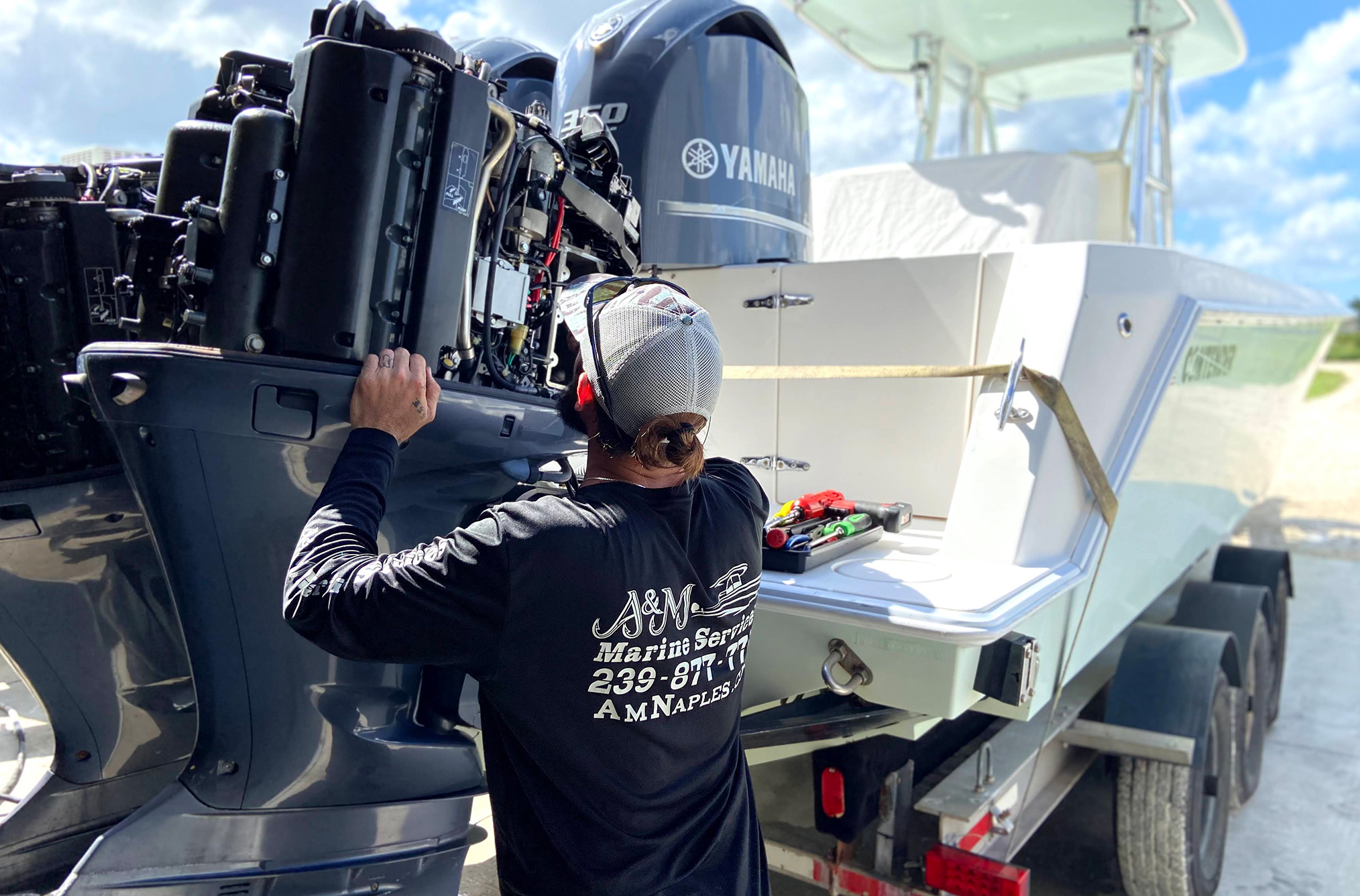 A&M Marine employee working on an outboard motor